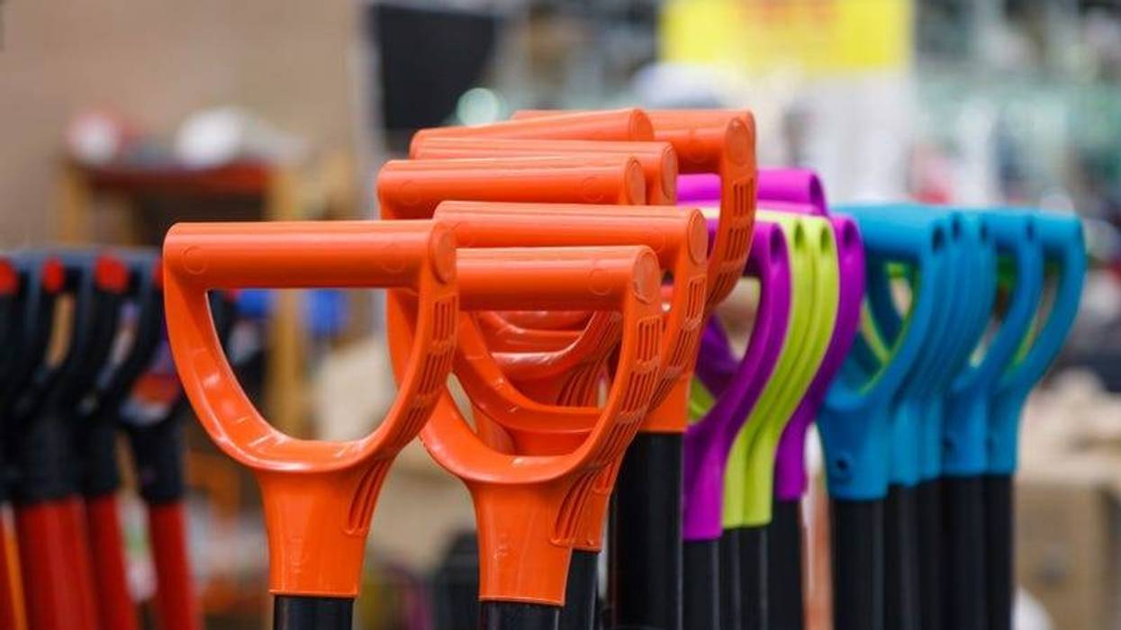Colored plastic handle shovels in the store building tools.