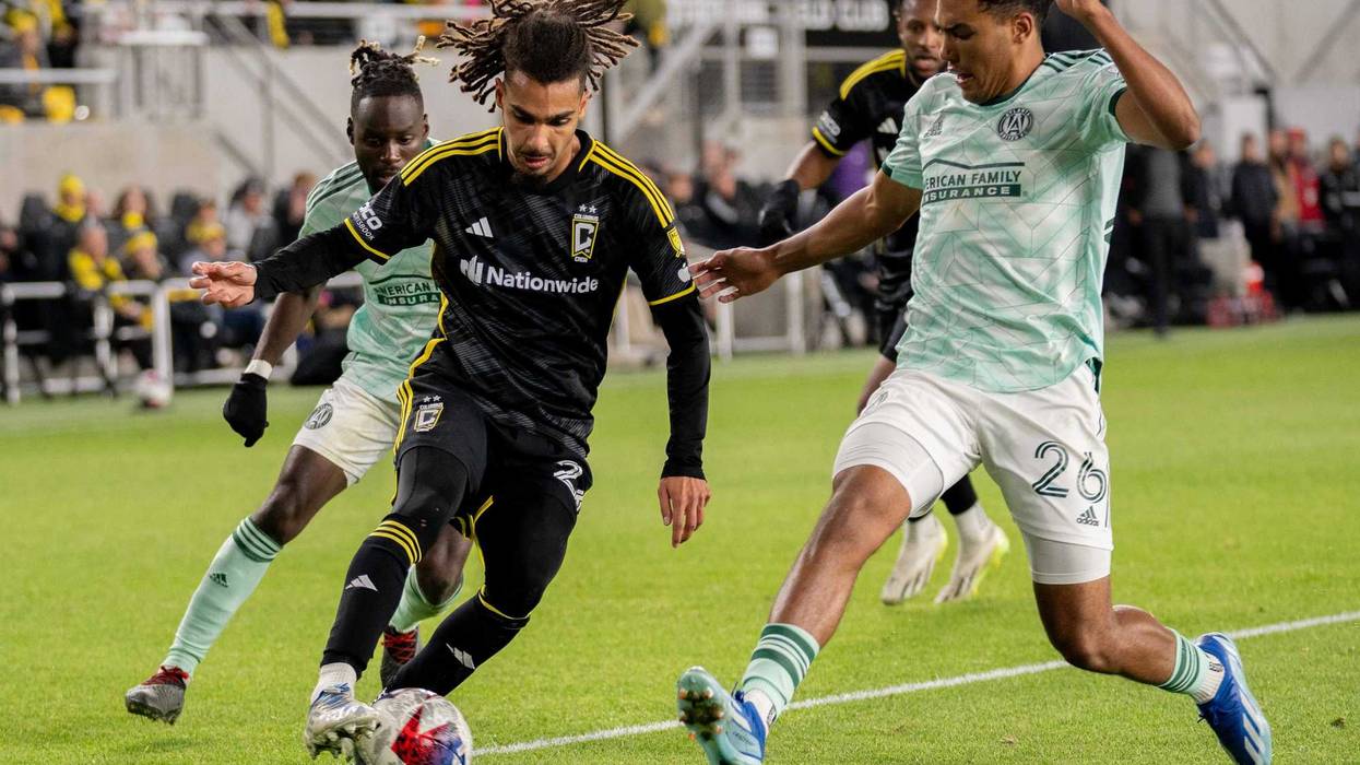Columbus Crew defender Mohamed Farsi runs towards the goal through Atlanta United defenders