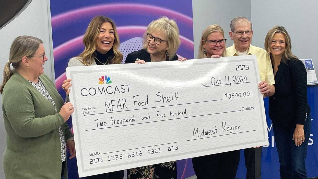 Comcast donates to NEAR Food Shelf at Xfinity store opening in Crystal, Minnesota.