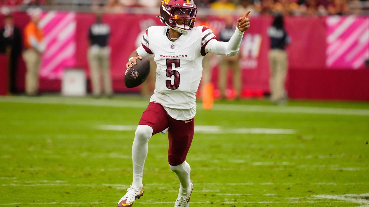 Commanders quarterback Jayden Daniels (5) looks for open receivers against the Cardinals during a game at State Farm Stadium in Glendale on Sept. 29, 2024.