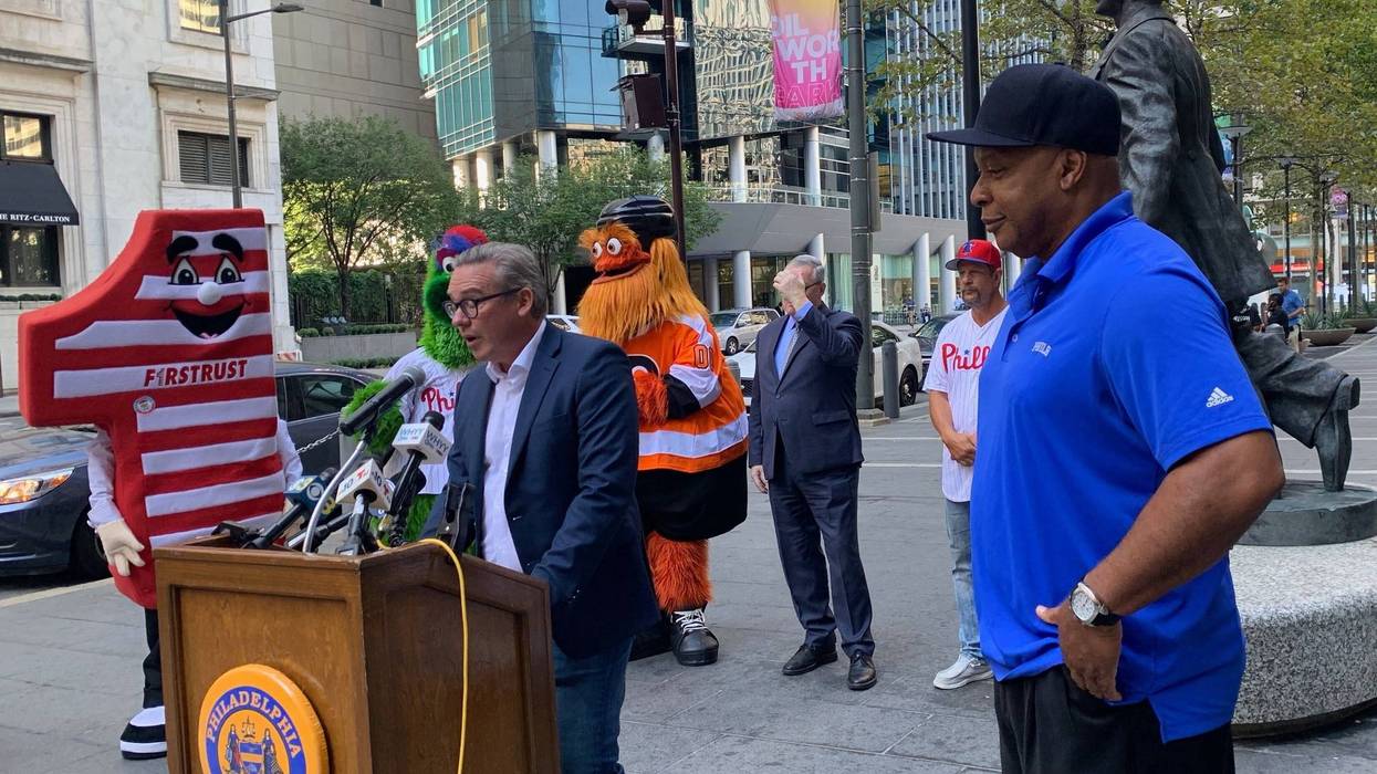 Committee of Seventy President and CEO Al Schmidt talking outside Philadelphia City Hall during Tuesday's National Voter Registration Day with former Philadelphia 76ers star World B. Free in the foreground. Mascots including the Philadelphia Flyers' Gritty and the Philadelphia Phillies' Phanatic join Mayor Jim Kenney in the background.