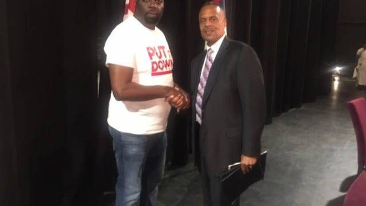 Community activist Darryl Shuler shakes hands with Philadelphia Police Commissioner Richard Ross.