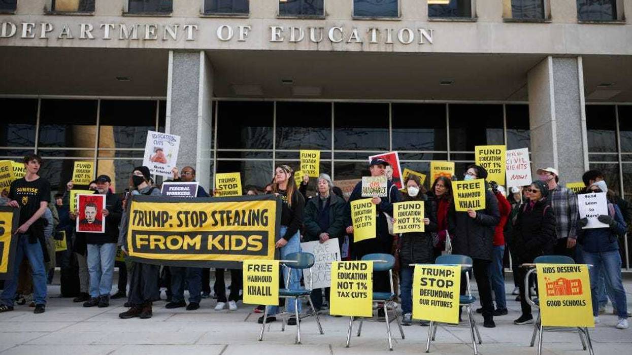 Community members rally in front of the Department of Education with school desks to protest budget cuts on March 13, 2025 in Washington, DC.