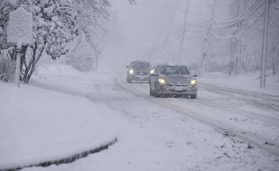 Commuters drive through snow in Norwood, New Jersey, on February 13, 2024