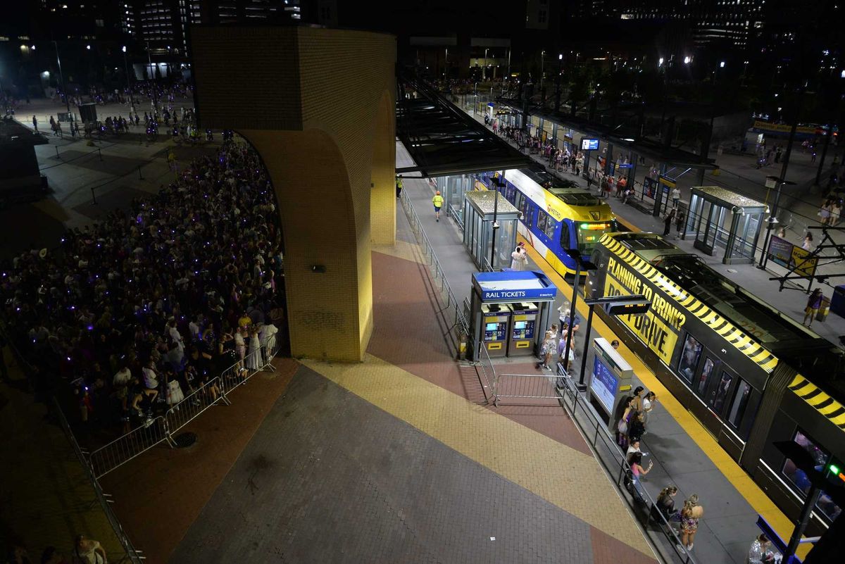 Concertgoers waiting for trains outside U.S. Bank Stadium.