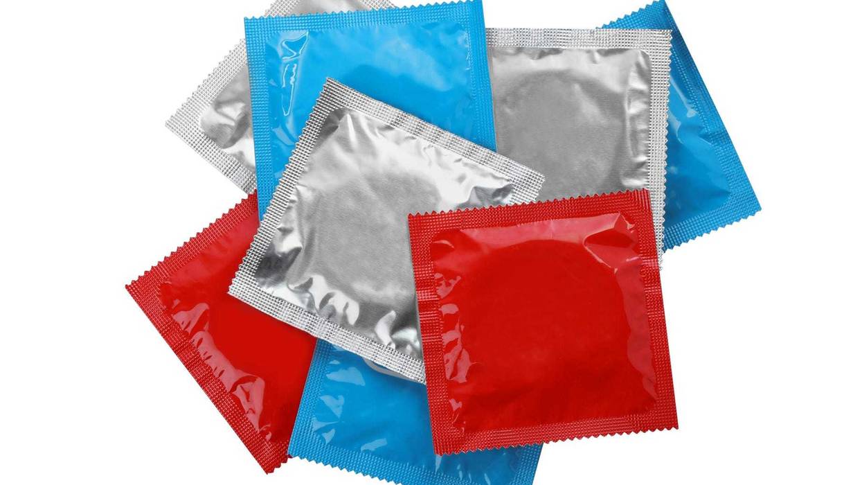 Condom packages isolated on white, top view. Safe sex