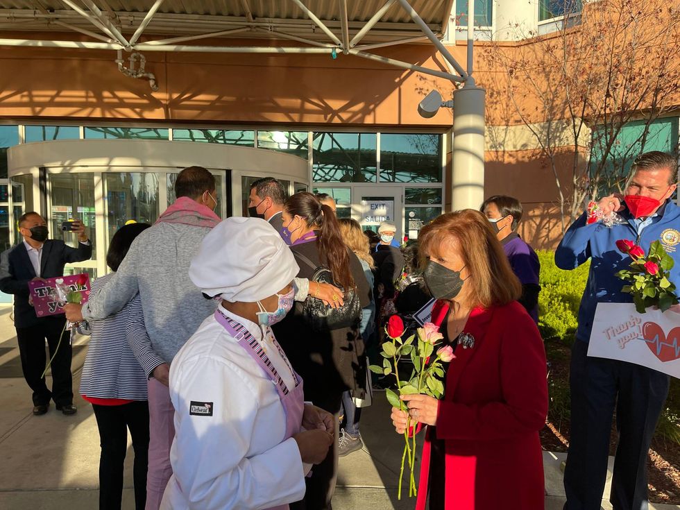 Congresswoman Jackie Speier hands roses to healthcare workers at San Mateo Medical Center.