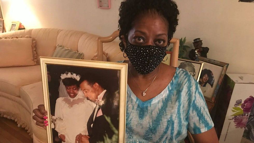 Connie Renfrow holds up a picture from her wedding day