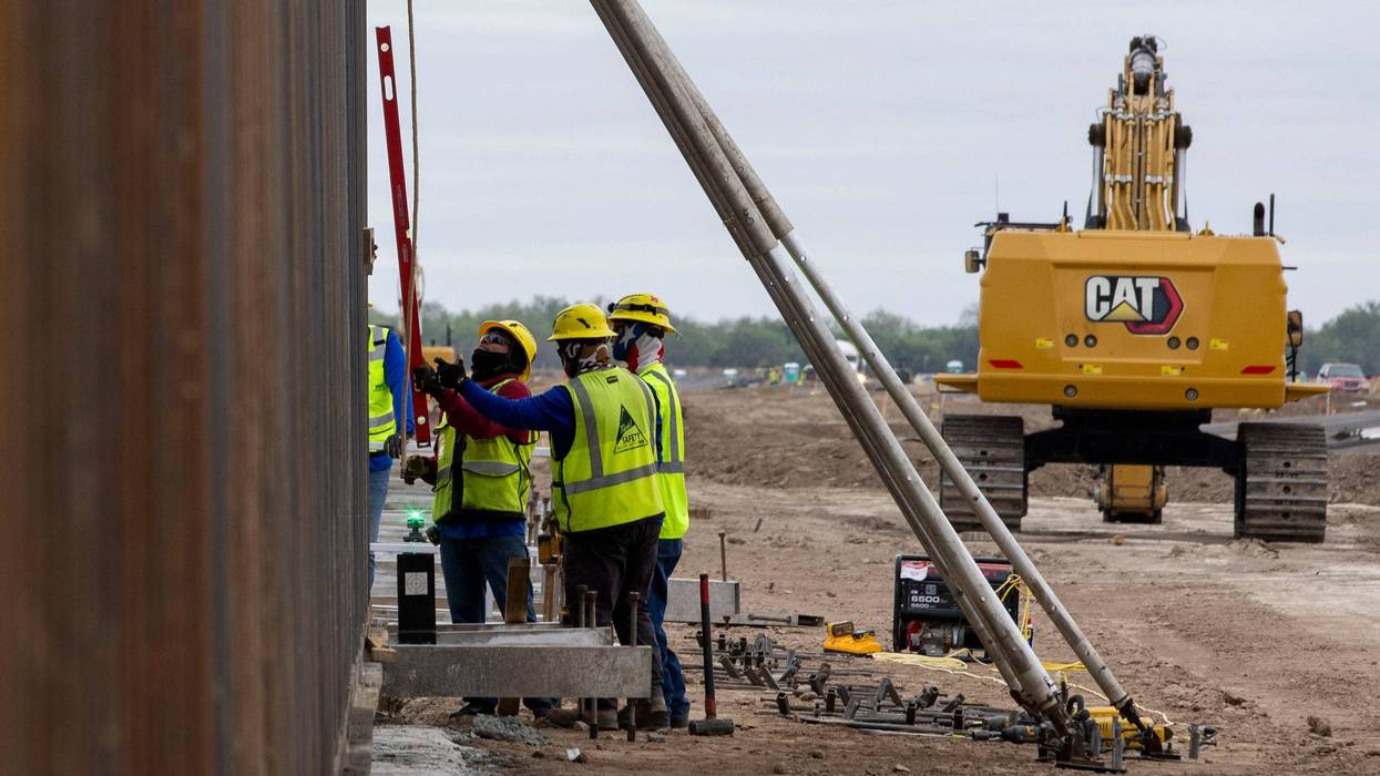 Construction crews install panels of the border wall where Texas Land Commissioner Dawn Buckingham is to hold a news conference to commemorate the state-sponsored construction on November 26, 2024 in La Casita-Garciasville, Texas.