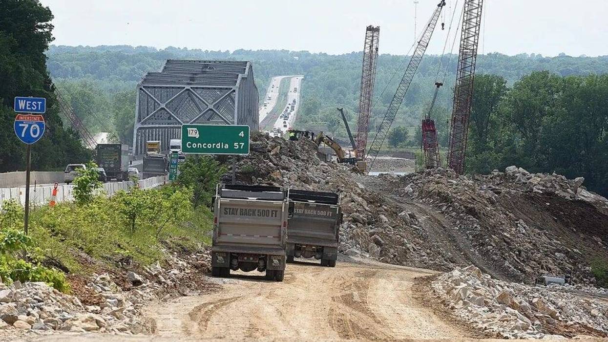 Construction workers haul limestone quarried from the river bluff to the construction site of a new Interstate 70 Missouri River bridge connecting Boone and Cooper counties