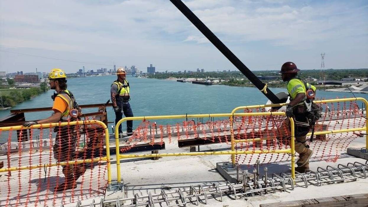 Construction workers on top of Gordie Howe International Bridge