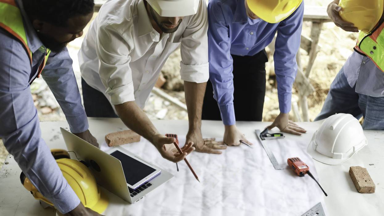 Construction workers reviewing building plans
