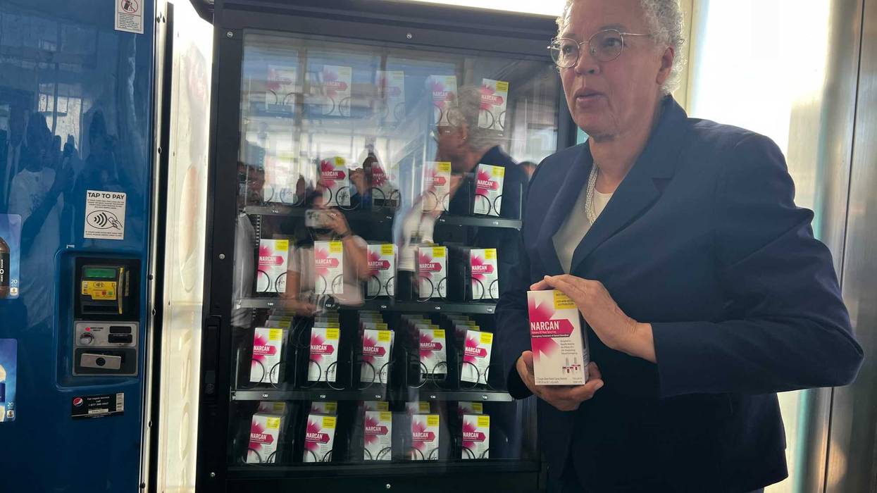 Cook County Board President Toni Preckwinkle holds up a box of naloxone, or Narcan, at the naloxone vending machine at the CTA 47th Street Red Line Station. Cook County Health and the CTA launched vending machines at five CTA stations throughout the city.