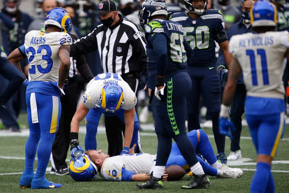Cooper Kupp checks on John Wolford after the quarterback took a hard hit.