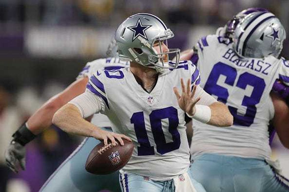 Cooper Rush drops back to pass for the Cowboys