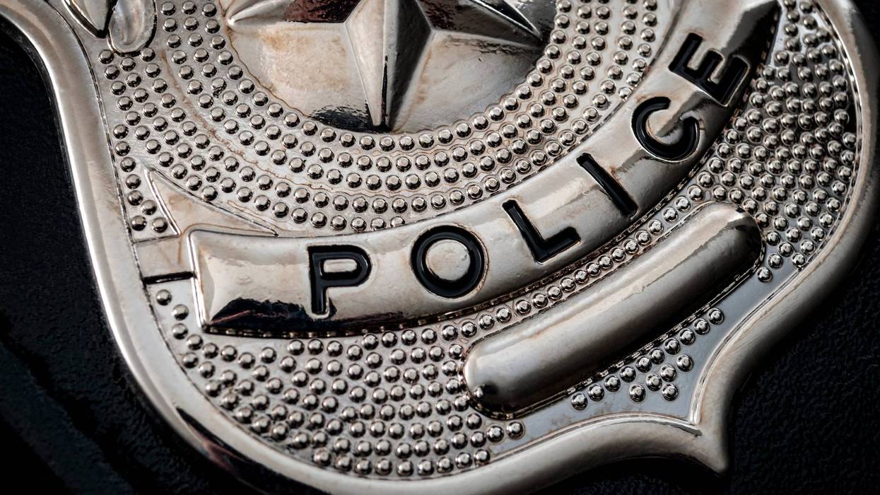 Cops and police officer badge with macro close up on the "police" text of a cop badge