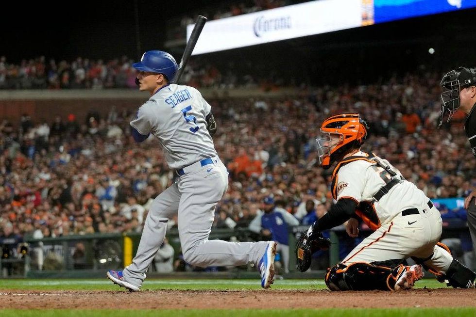 Corey Seager #5 of the Los Angeles Dodgers watches his RBI double to score Mookie Betts #50 against the San Francisco Giants during the sixth inning.