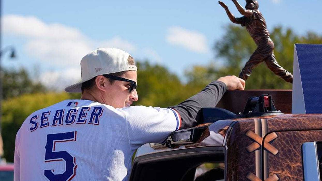 Corey Seager #5 of the Texas Rangers rides in a truck bed during the World Series Championship parade at Globe Life Field on November 03, 2023 in Arlington, Texas.