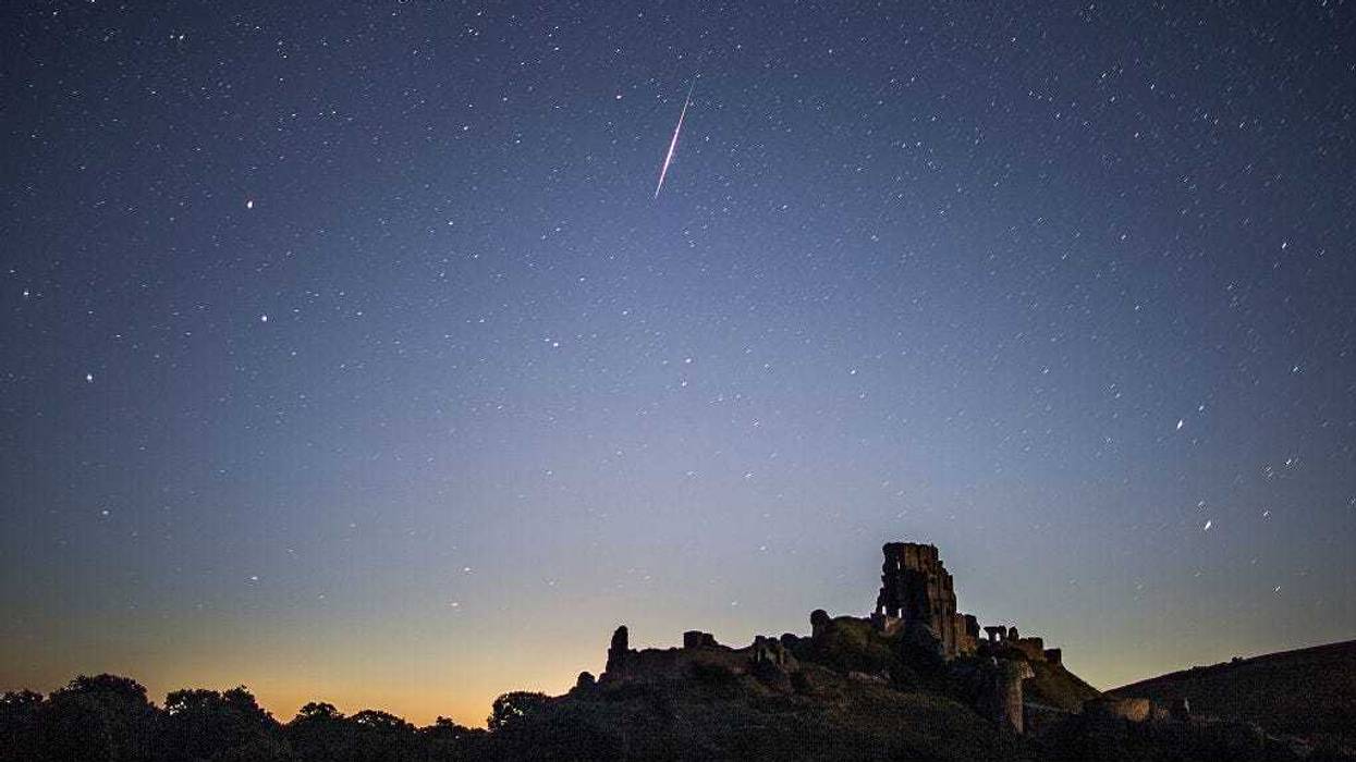 CORFE CASTLE, UNITED KINGDOM - AUGUST 12: A Perseid Meteor flashes across the night sky above Corfe Castle on August 12, 2016 in Corfe Castle, United Kingdom. The Perseids meteor shower occurs every year when the Earth passes through the cloud of debris left by Comet Swift-Tuttle, and appear to radiate from the constellation Perseus in the north eastern sky.