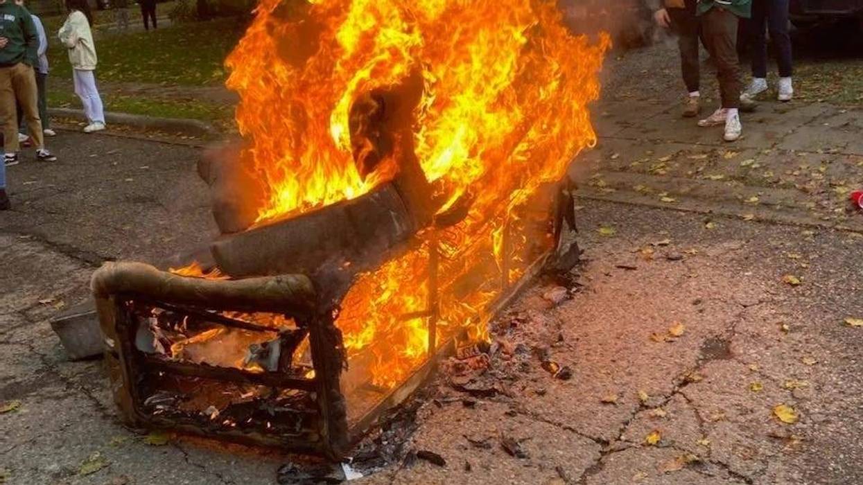 Couch set on fire by football fans in Michigan.