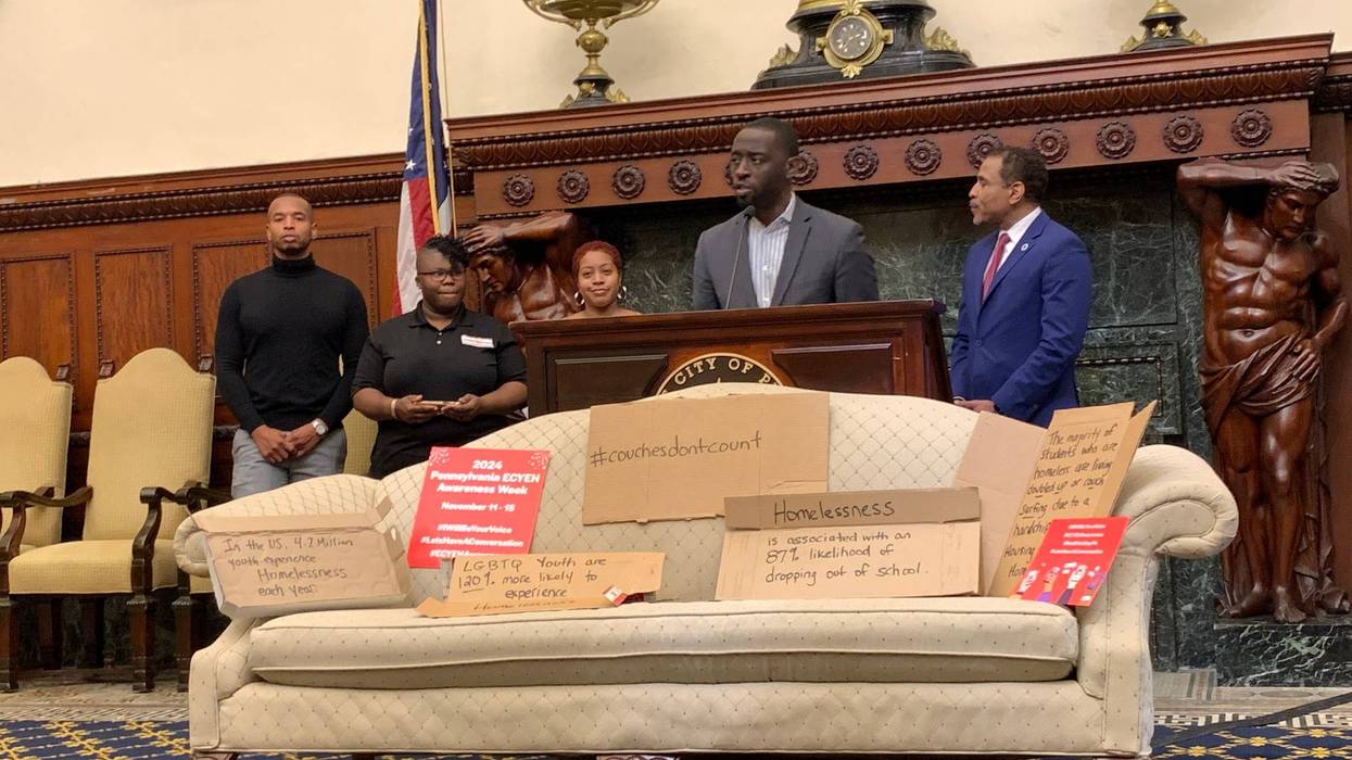 Councilmember Isaiah Thomas stands in front of a couch in the Mayor's Reception Room on Tuesday.