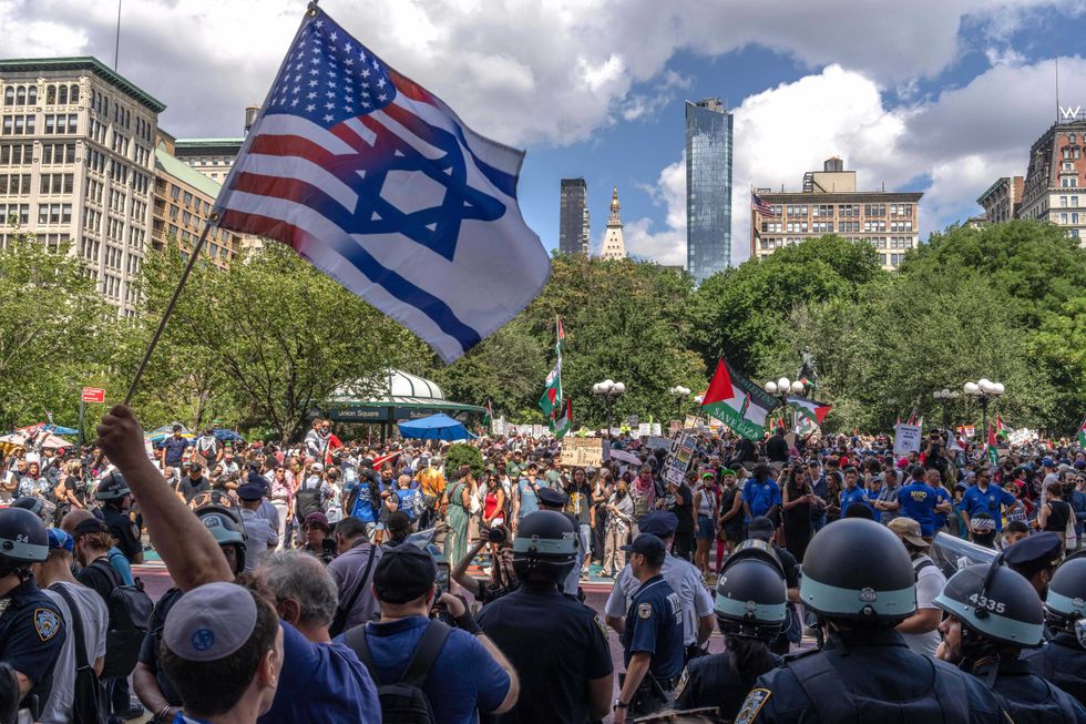 Counter-protesters hold an Israeli-American flag across the street from a pro-Palestinian protest at Union Square on Labor Day
