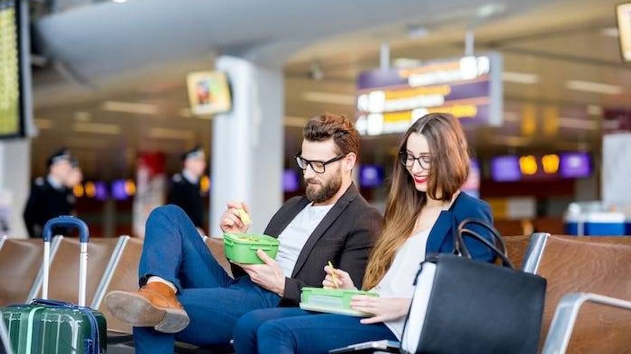 Couple eating while waiting at the airport