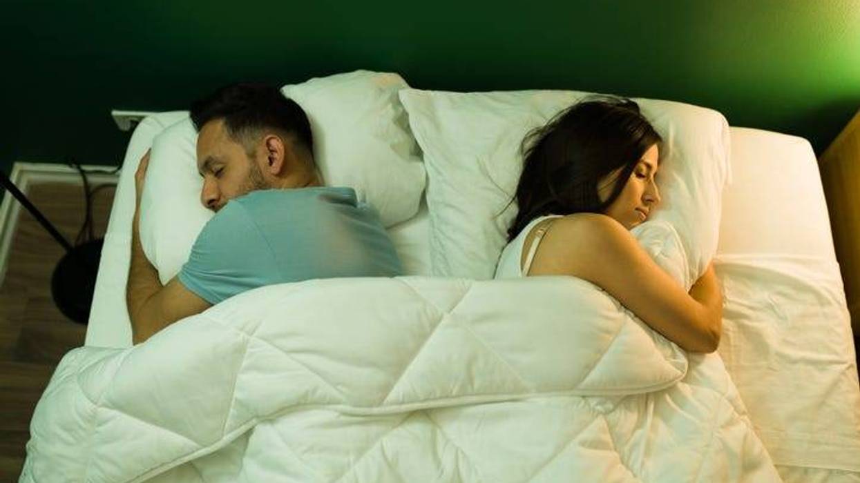 Couple Facing Opposite Directions In Bed