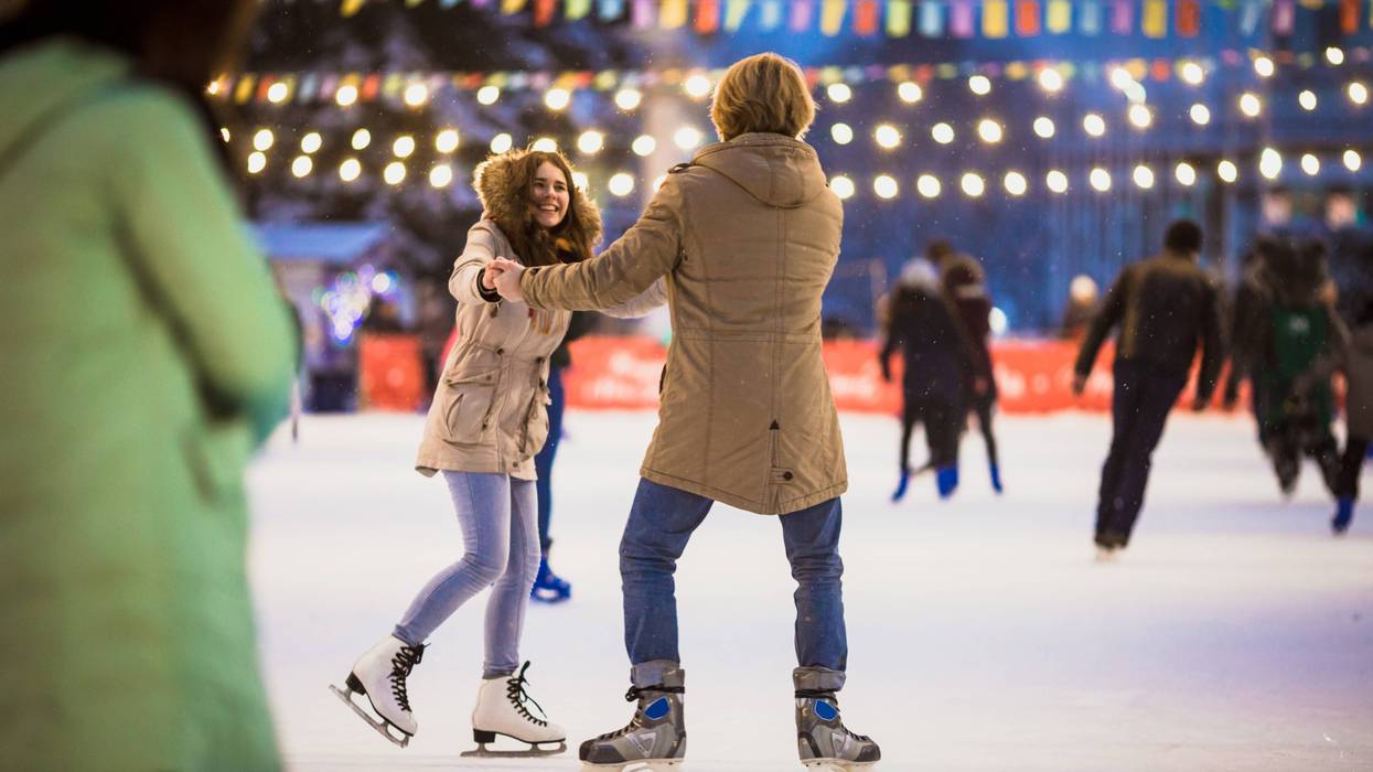 Couple ice skating on outdoor rink