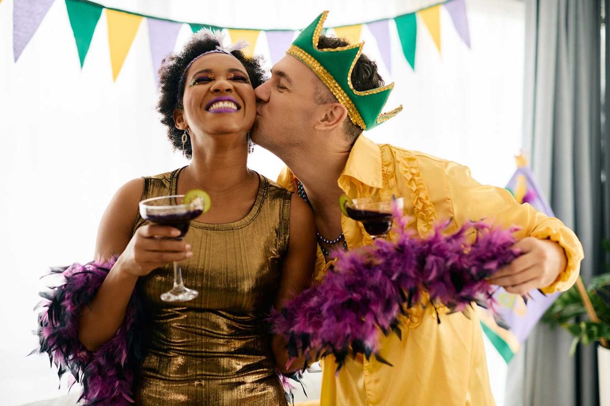 Couple kissing on Mardi Gras.