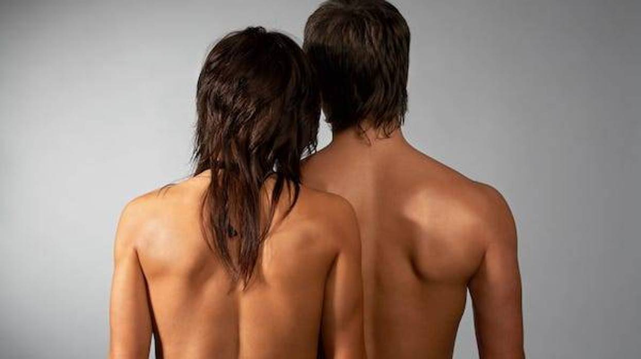 Couple posing naked with backs turned