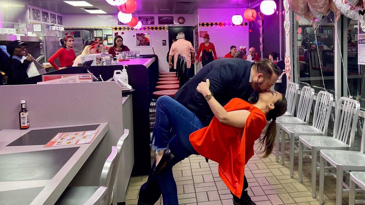 Couple shares a romantic kiss in their local Waffle House.