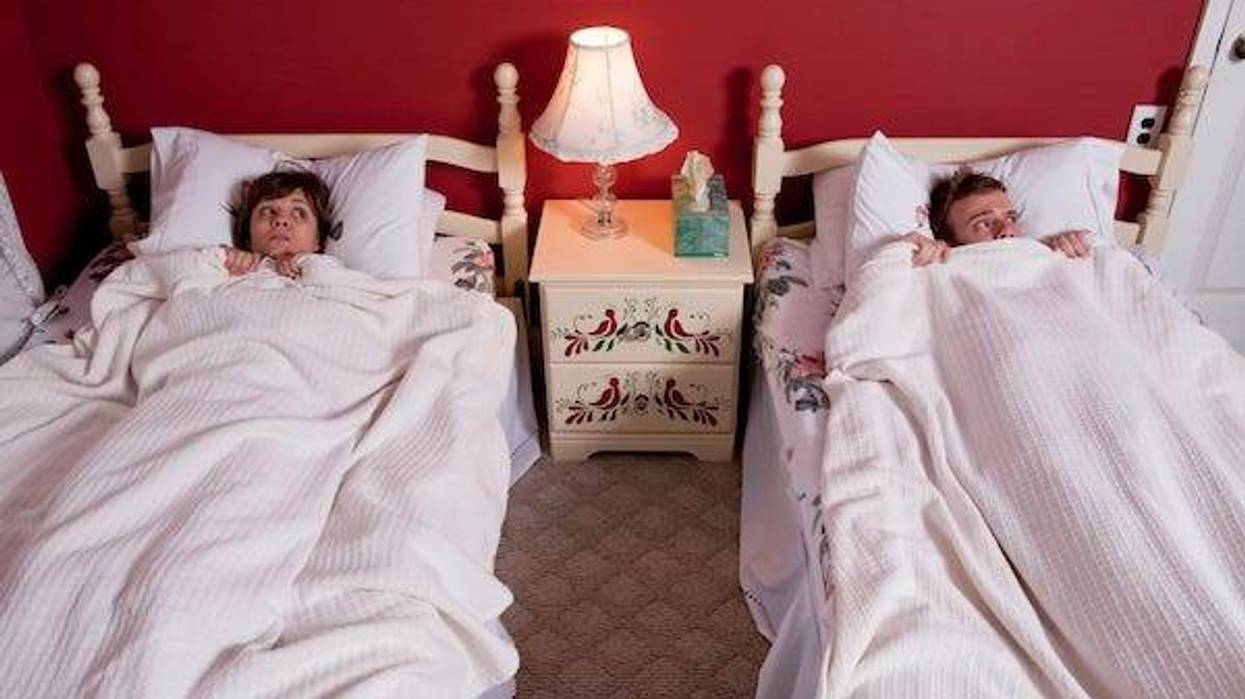 Couple sleeping in separate beds