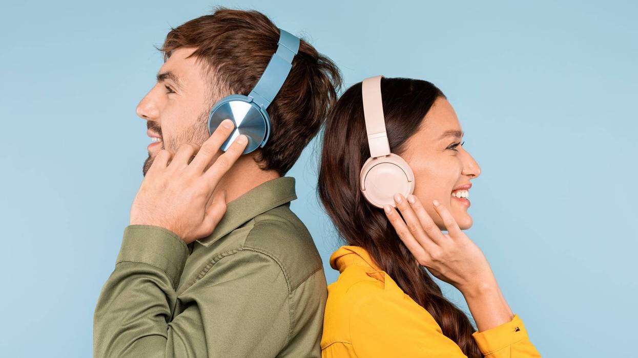 Couple Standing Together With Headphones On