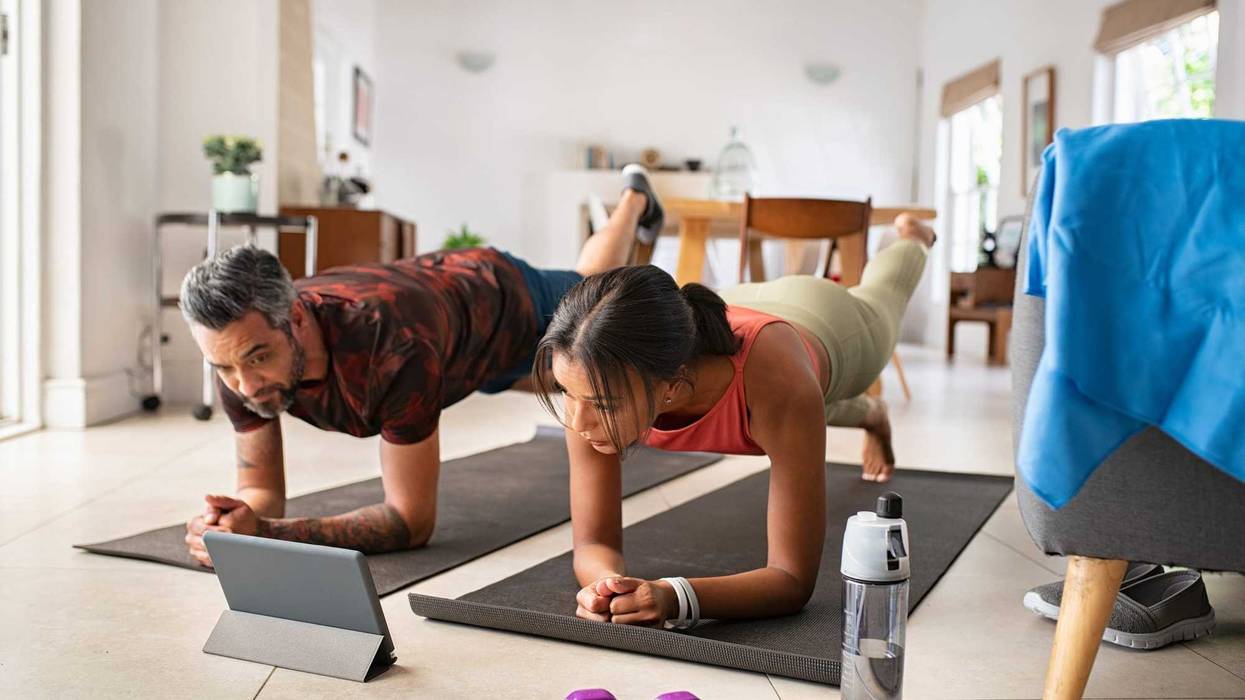 Couple working out with tablet stock photo.