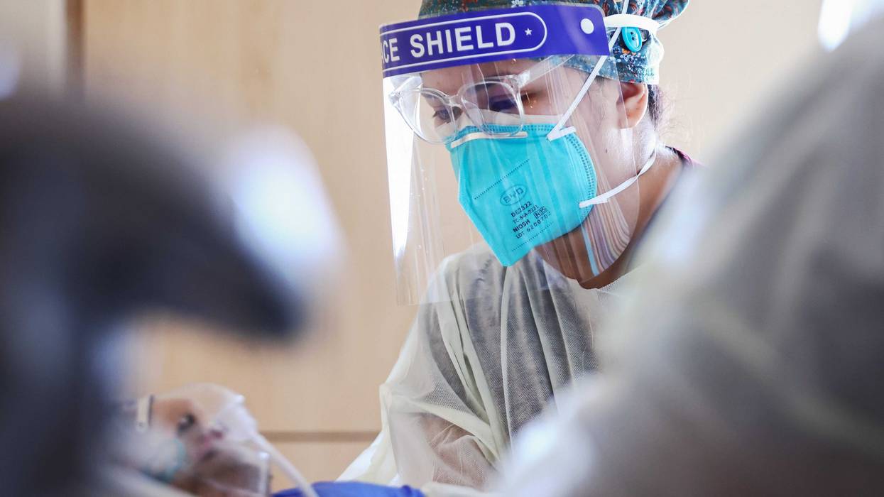 COVID-19 nurse treating hospital patient