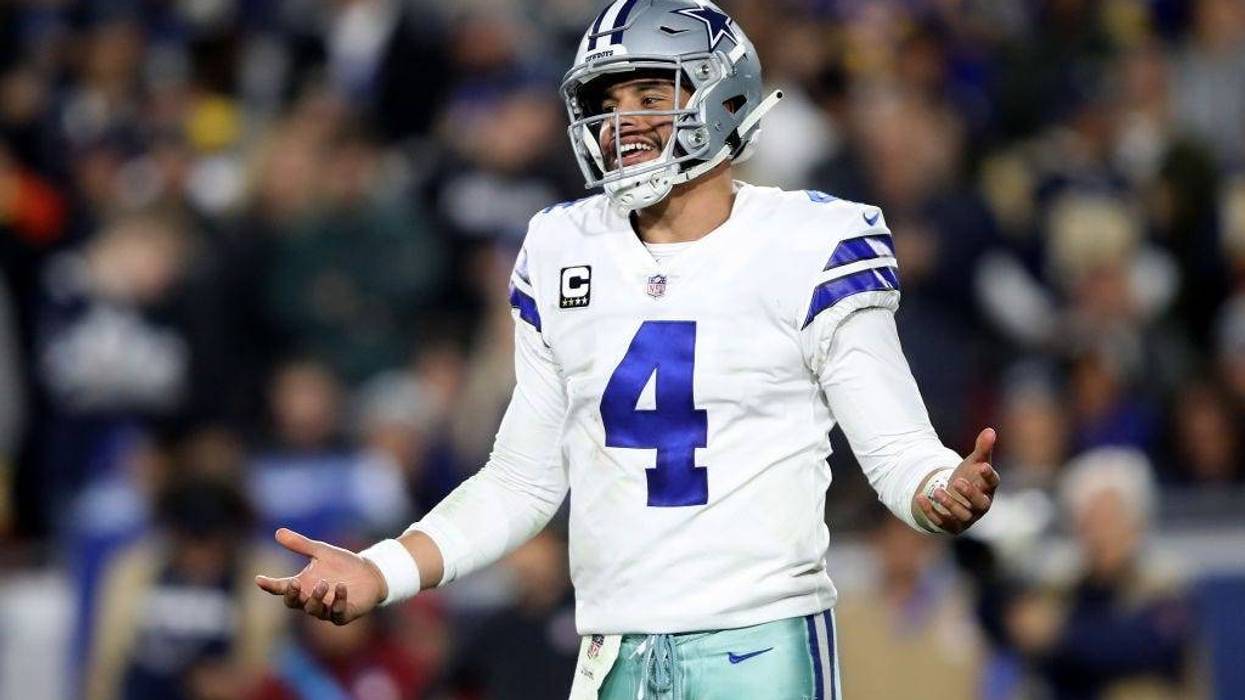 Cowboys quarterback Dak Prescott smiles during first half of game.