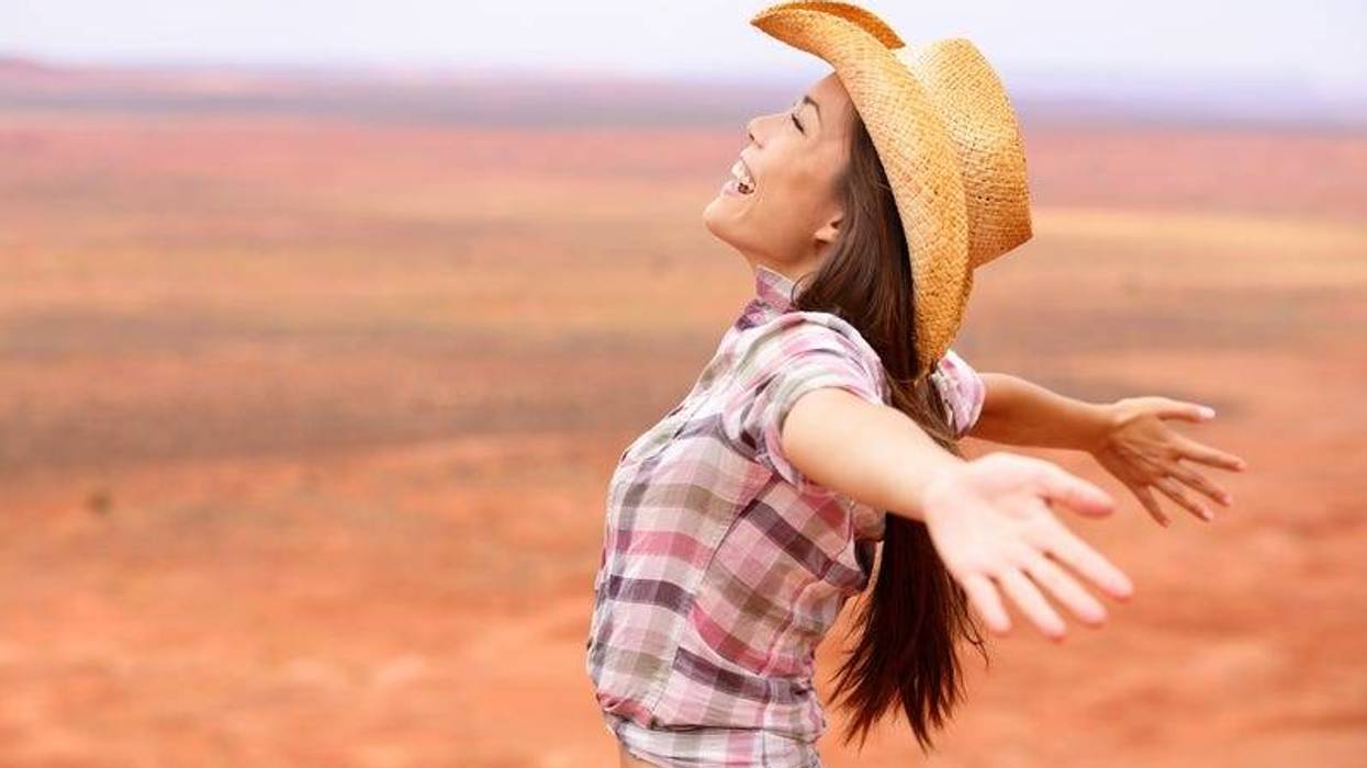 Cowgirl - woman happy and free on american prairie.