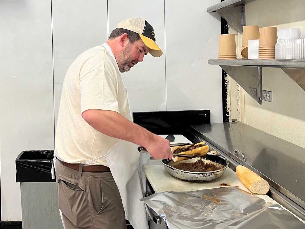 Craig Rutherford dips the pot roast sandwich in gravy