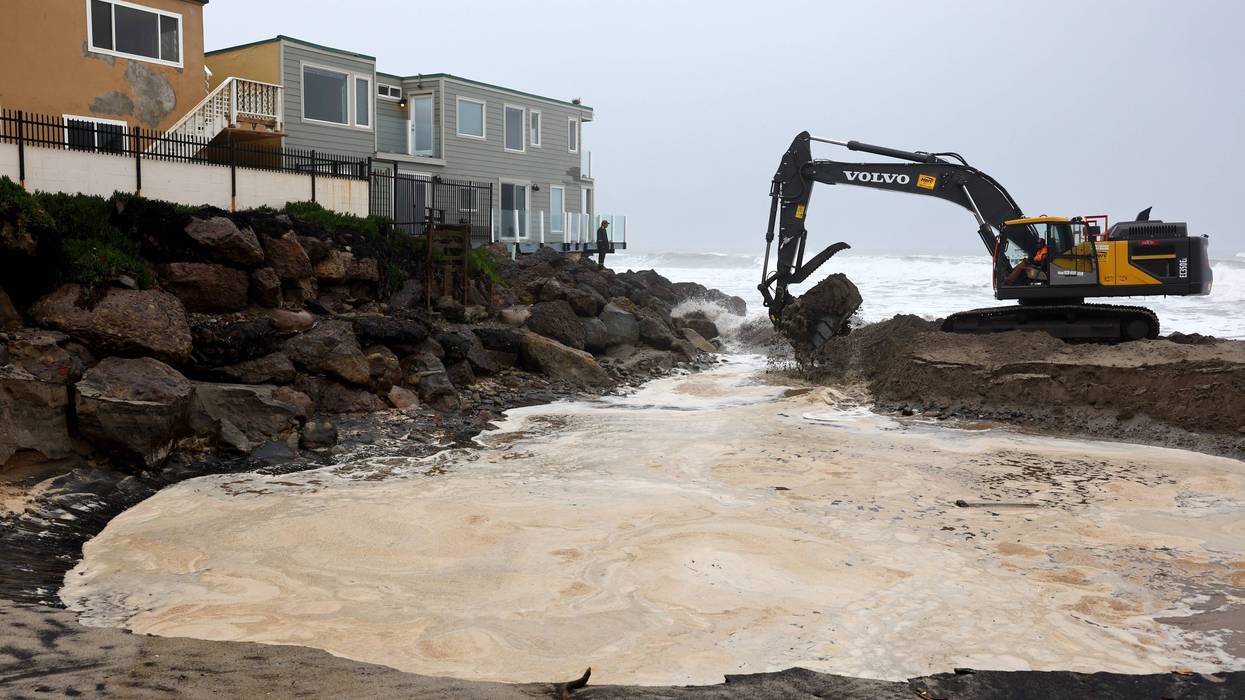 crane by houses near coastline