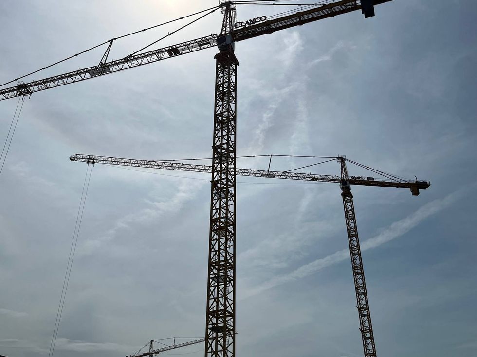 Cranes are seen in the area of the Cortex Innovation Community on May 17, 2022.