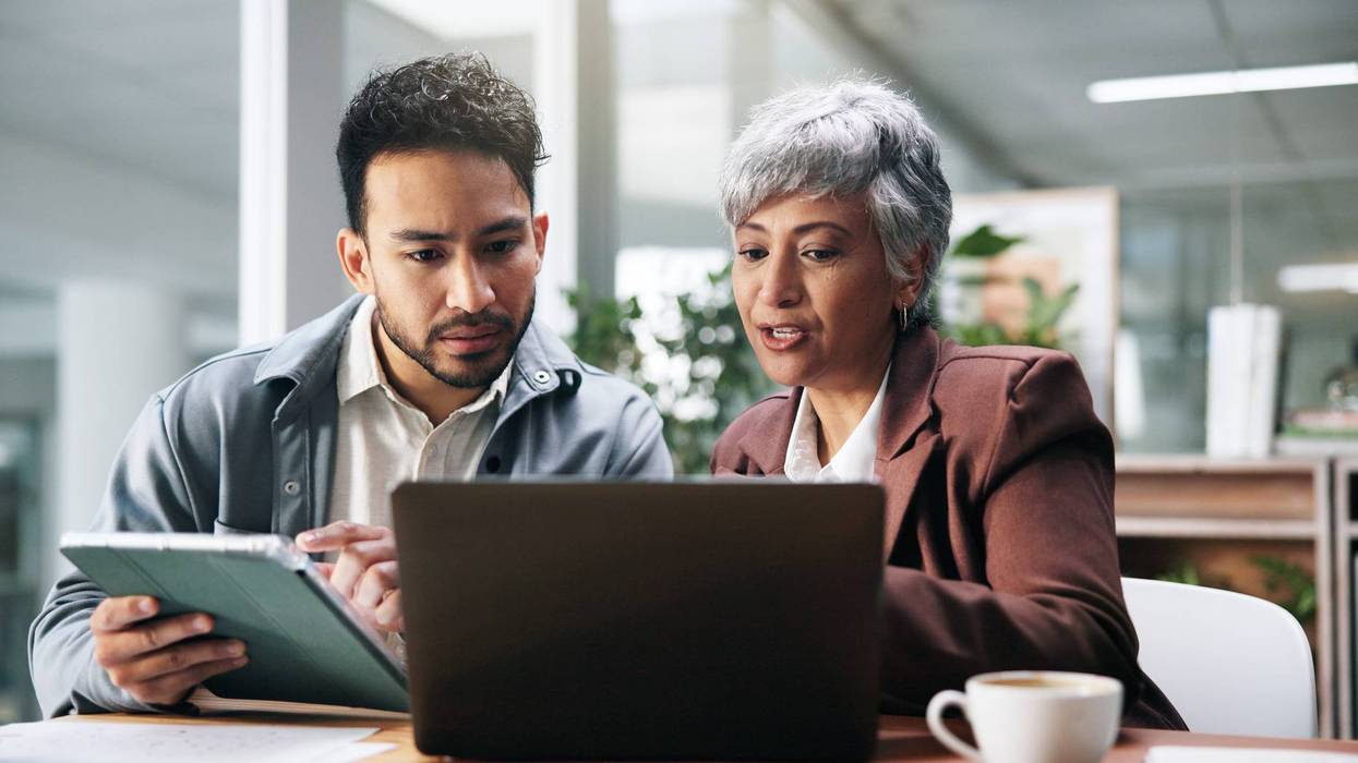 Creative people, tablet and laptop in office for planning, fact check and help with editor feedback. Staff, team and advice with tech for research, article comparison and information for publication