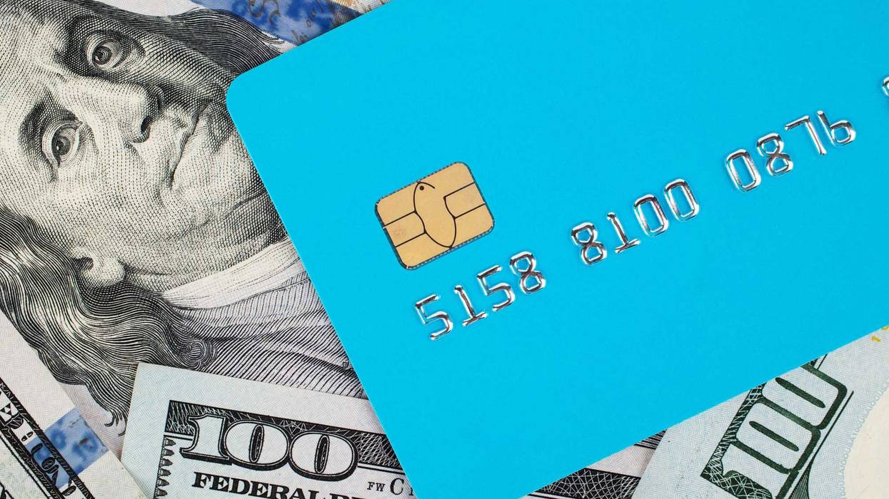 Credit card and dollar banknotes. The concept of payment for goods and services