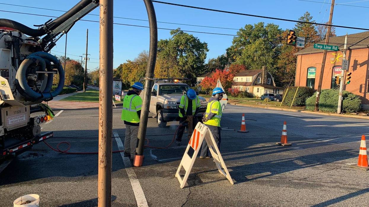 Crews from Pennsylvania American Water dig in the street on Township Line Road near Dekalb Pike in Whitpain Township, Montgomery County, the site of an overnight water main break.
