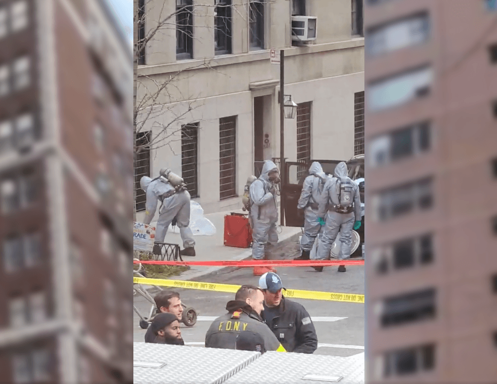 Crews in hazmat suits probed the Jeep after a woman was found dead of a suspected suicide with toxic chemicals inside .
