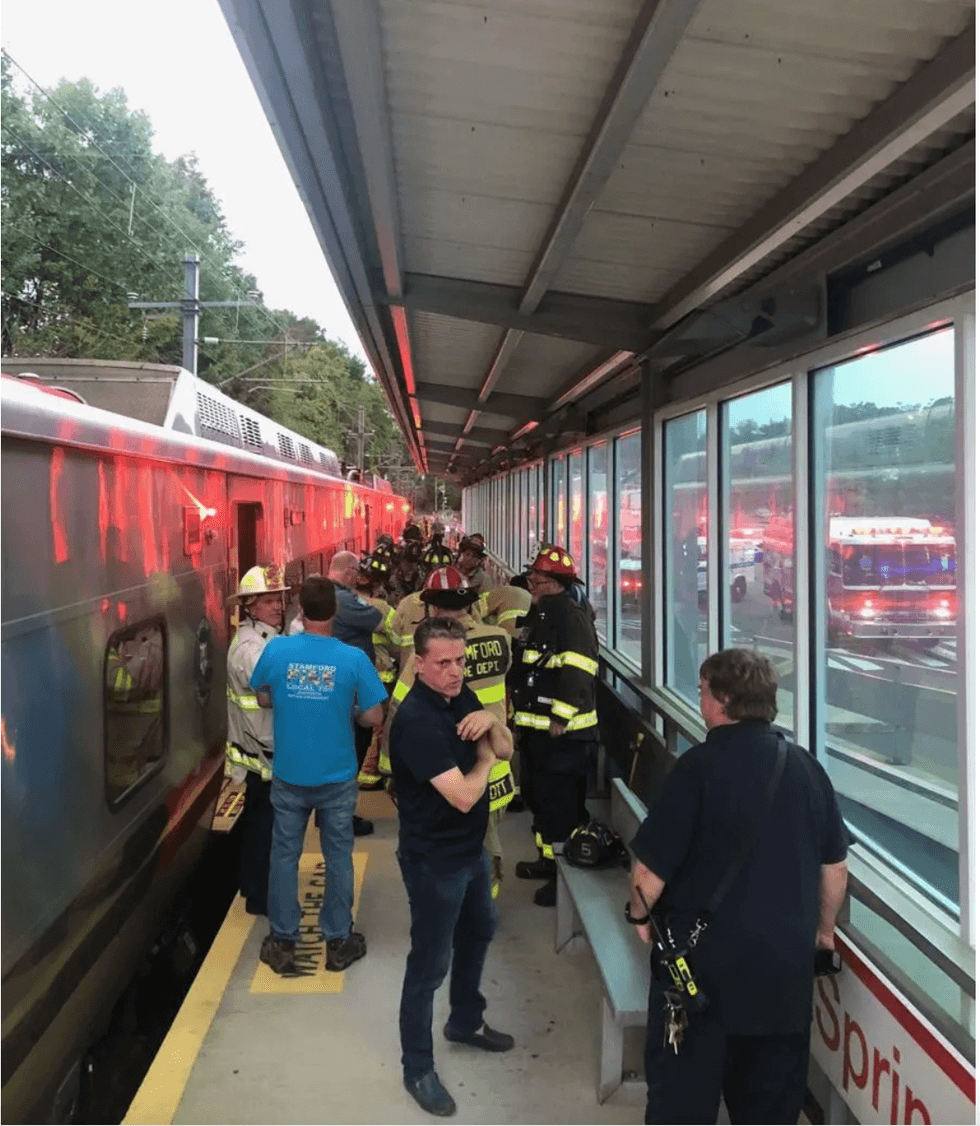 Crews rescue woman from underneath train