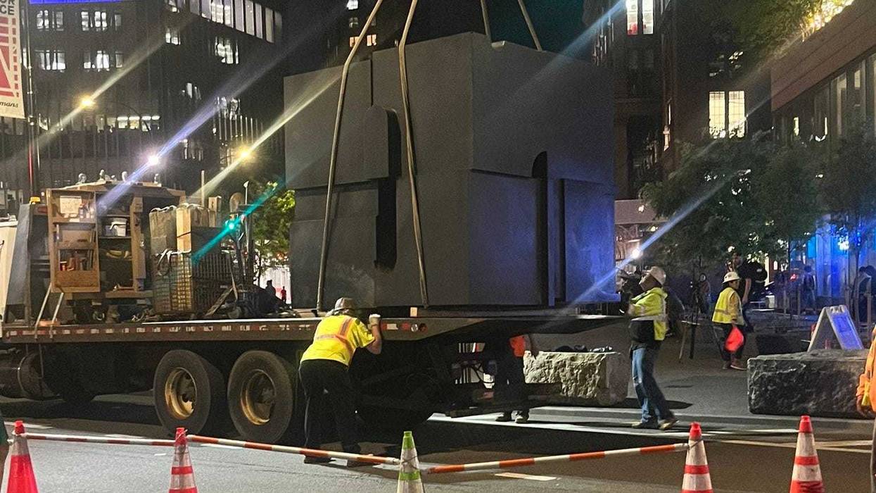 Crews secured The Cube on a flatbed truck Monday night so it could be taken to a foundry in Connecticut