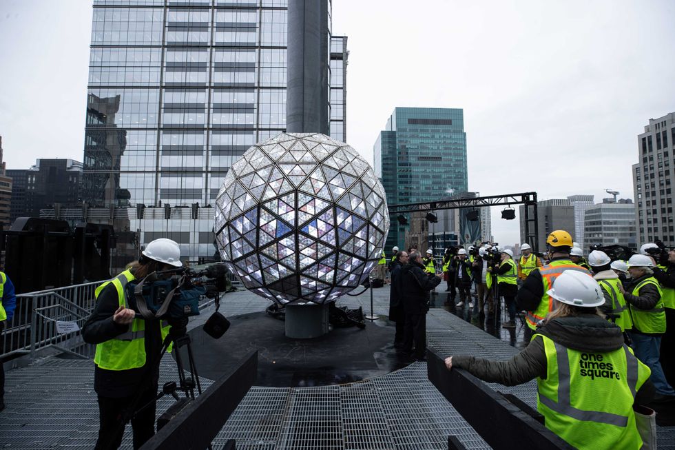 Crews work atop One Times Square on Dec. 27, 2023