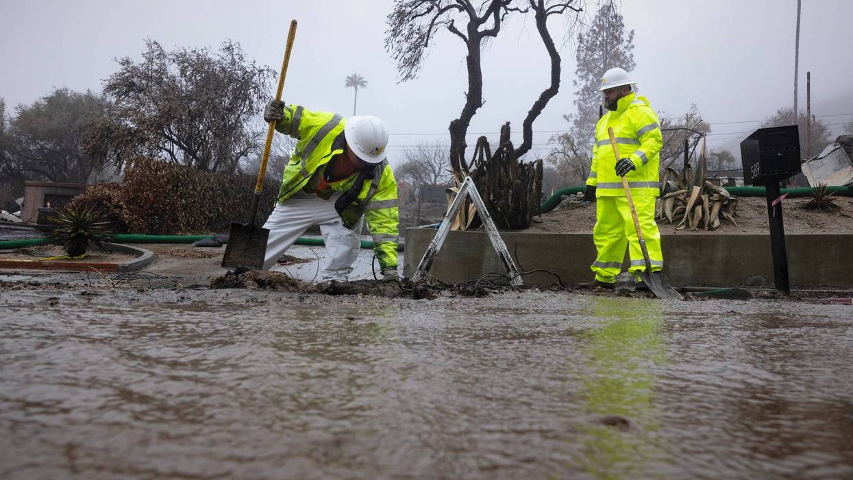 Crews work in the rain in the Eaton Fire zone during a storm Thursday, Feb. 13, 2025, in Altadena, Calif.