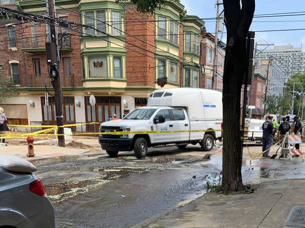 Crews work to get a water main break at Sixth and Bainbridge Streets under control.
